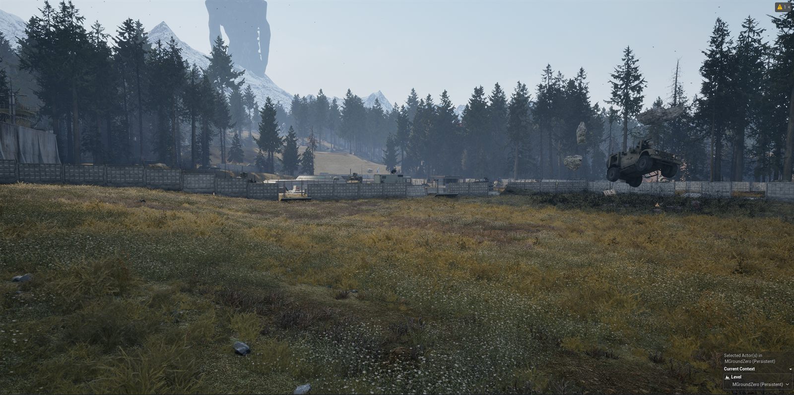A wide field in front of a pine forest and a walled compound, with a huge dark vertical shape standing in the sky above distant mountains