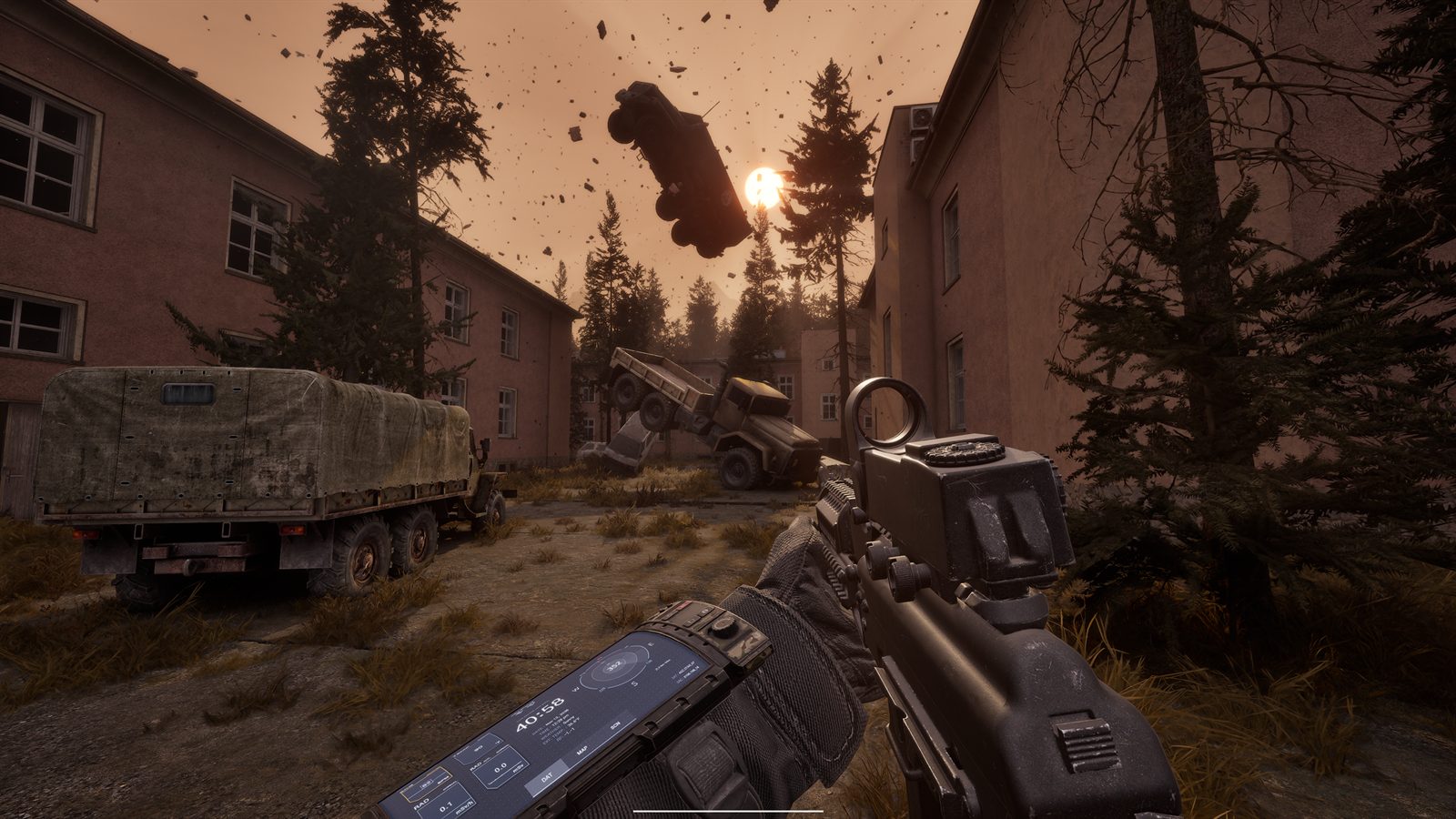 A street between old barracks buildings under an orange sky, a rifle in the foreground, with a car and debris hanging in the air