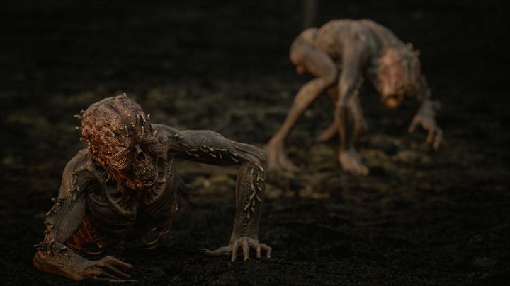 Two Reavers crawling across dark ground