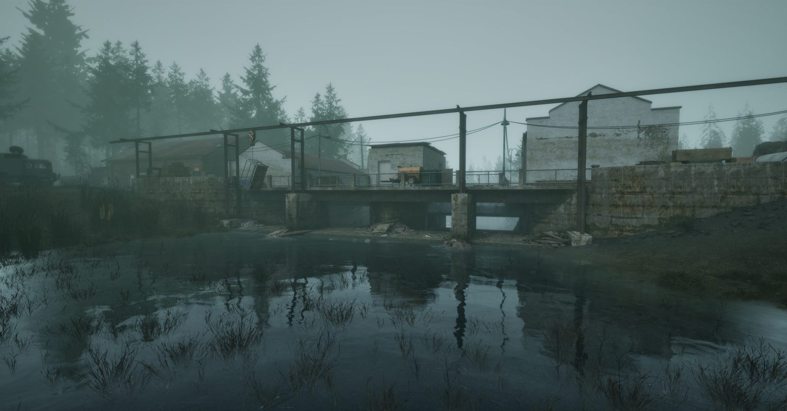 A concrete building and a metal walkway above dark still water in a foggy forest