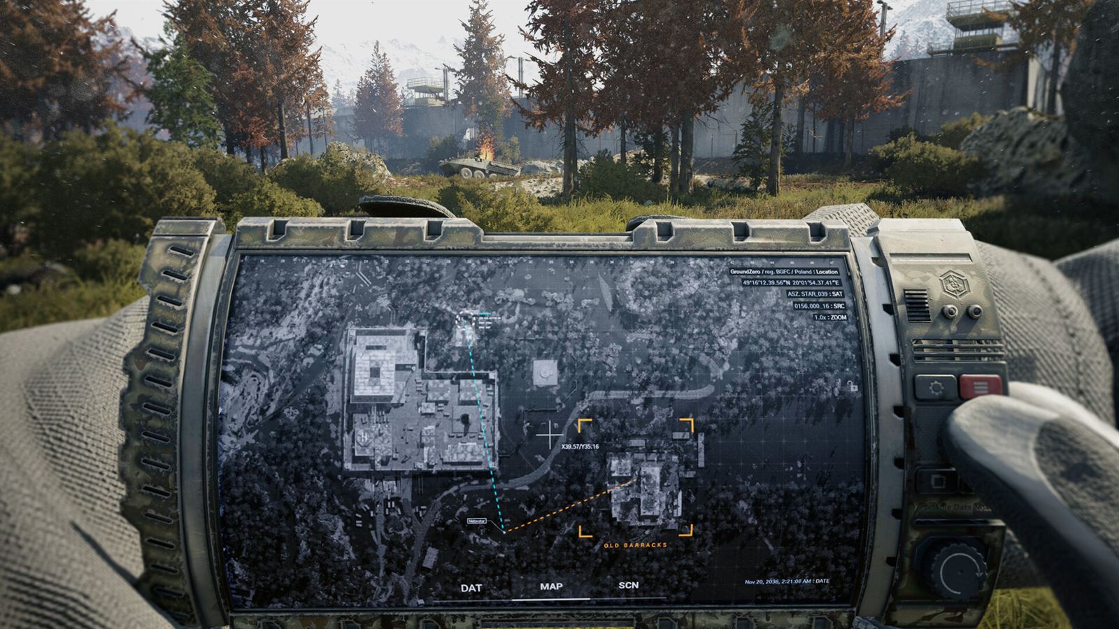 A gloved forearm turned upward to read a printed map pinned inside a rugged PDA screen